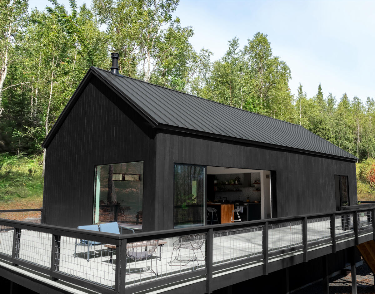 Benjamin Moore’s Woodluxe WB solid exterior stain in black (walls) and Cliffside Gray (porch floor) Benjamin Moore’s Woodluxe WB solid exterior stain in black (walls) and Cliffside Gray (porch floor)