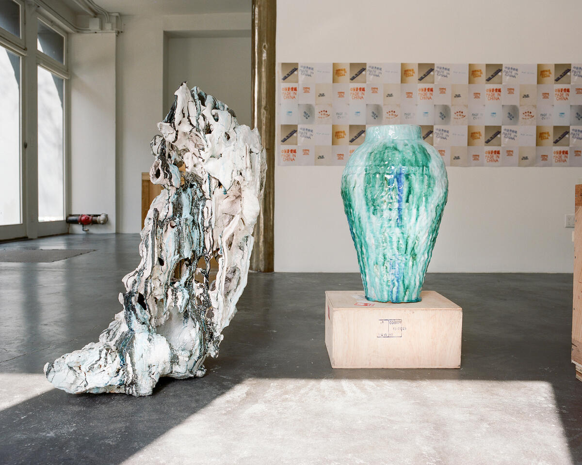 A scene from the “Made in China” exhibit at Objective Gallery, including Echo Flow in Blue on Black by Ryan Mitchell (left) and the Qing Bai copper floral vase by Matt Watterson